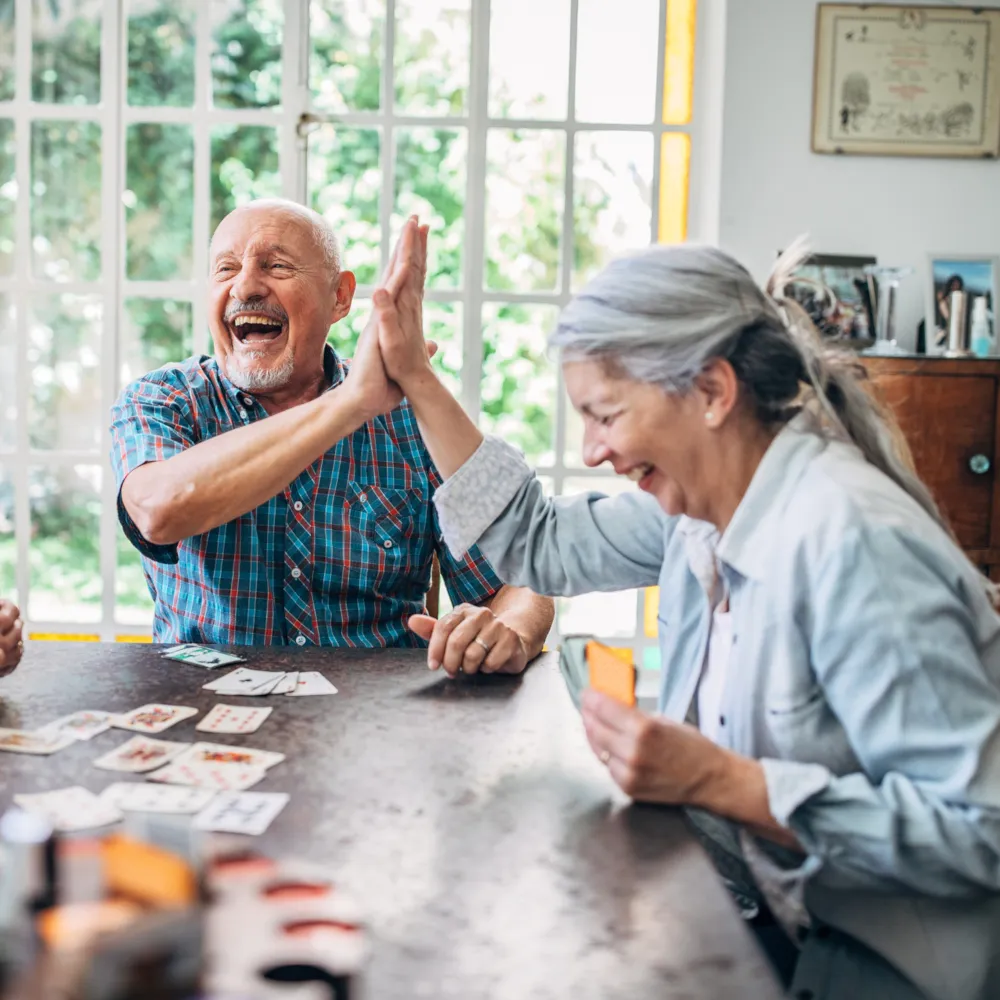 older couple winning at cards